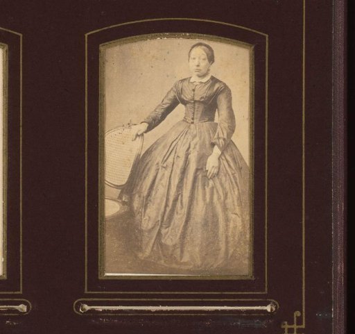 Portrait of a standing woman at a chair