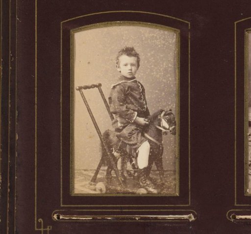 Portrait of a boy on a toy horse