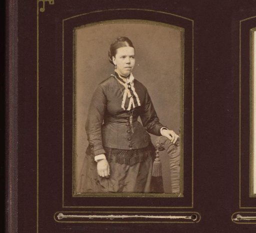 Portrait of a woman standing by a chair