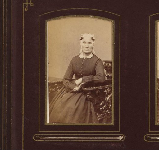 Portrait of a seated woman with cap and ear-strings