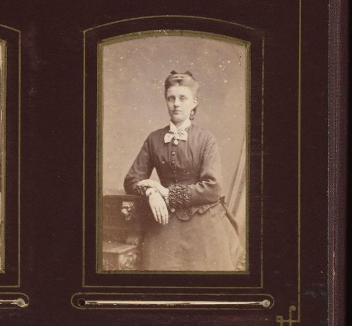 Portrait of a Young Woman Leaning on a Writing Desk