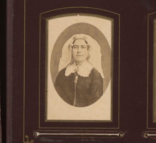 Portrait of a young woman with Zeeland cap with ear-strings and necklace