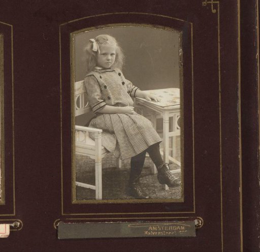 Portrait of a girl, seated at table