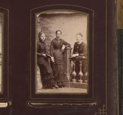 Portrait of three women, leaning on a tree stump and standing at a balustrade