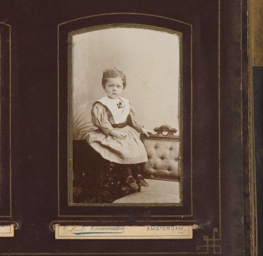 Portrait of a seated girl in dress with sailor collar