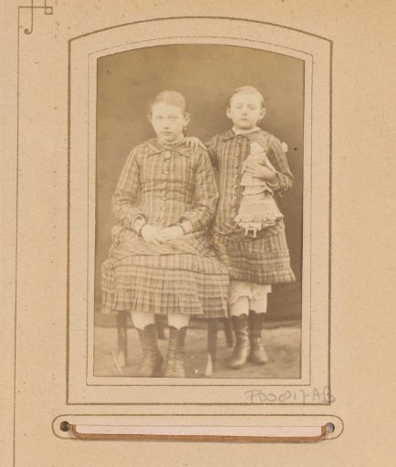 Portrait of two girls with a doll