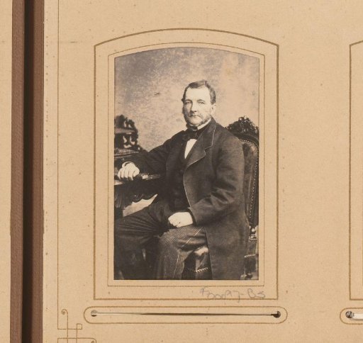 Portrait of a seated man with a book