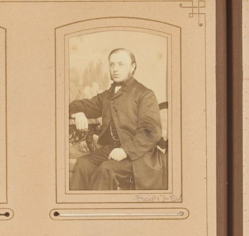 Portrait of a seated man with sideburns