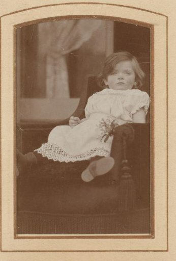 Portrait of a girl, seated in a chair
