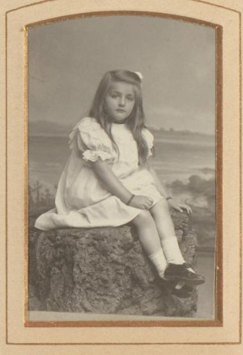 Portrait of a girl seated on a rock