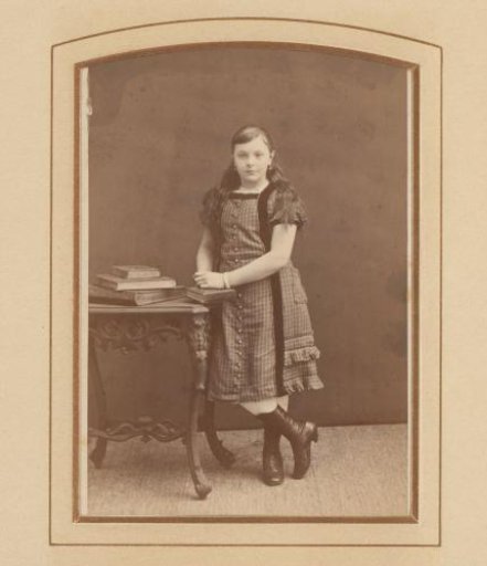 Portrait of a Girl Standing at a Desk