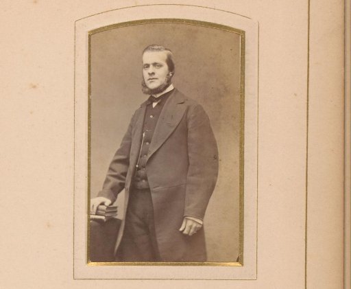 Portrait of a man at a table with books