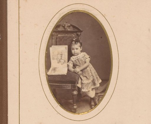 Portrait of a girl by a chair with an open sketchbook