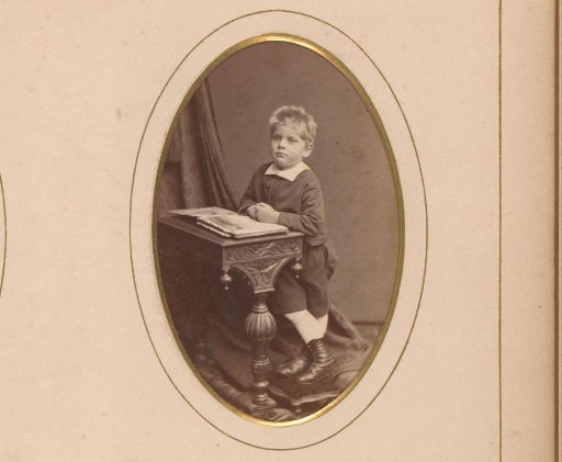 Portrait of a boy at a lectern with an open book