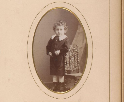 Portrait of a boy by a high chair