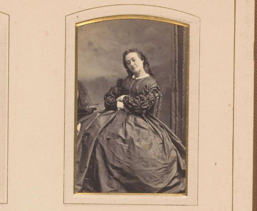 Portrait of a woman seated at a small table