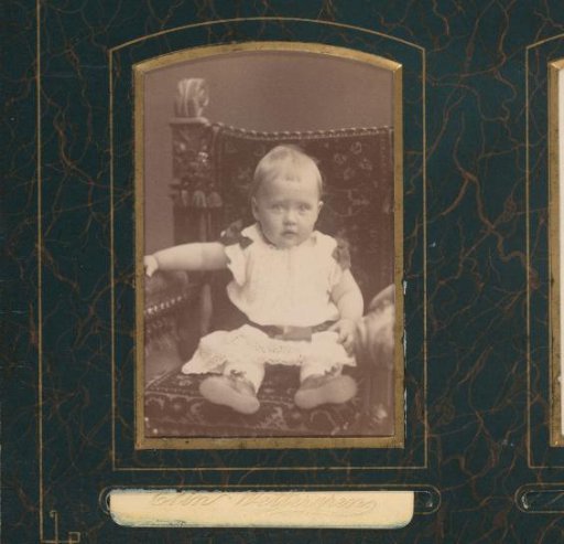 Portrait of a Child Sitting on a Chair