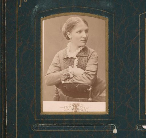 Portrait of a Seated Young Woman Leaning on the Arm of a Chair