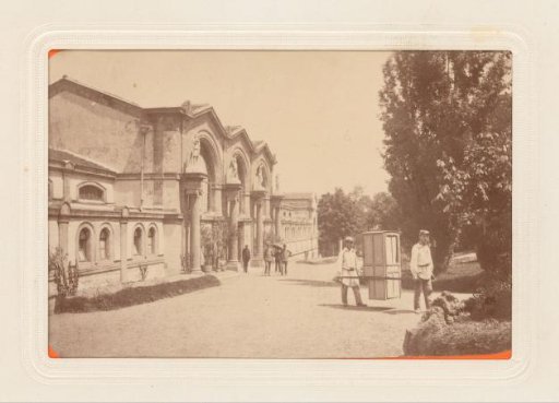 Two men carrying a sedan chair outside the baths of Royat, France