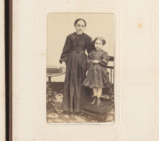 Portrait of a woman and a girl standing on a prayer stool