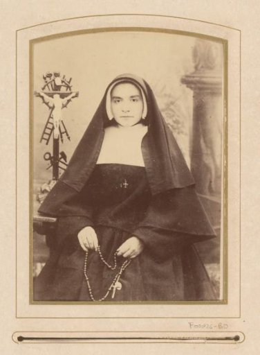 Portrait of a seated nun with a rosary in her hand