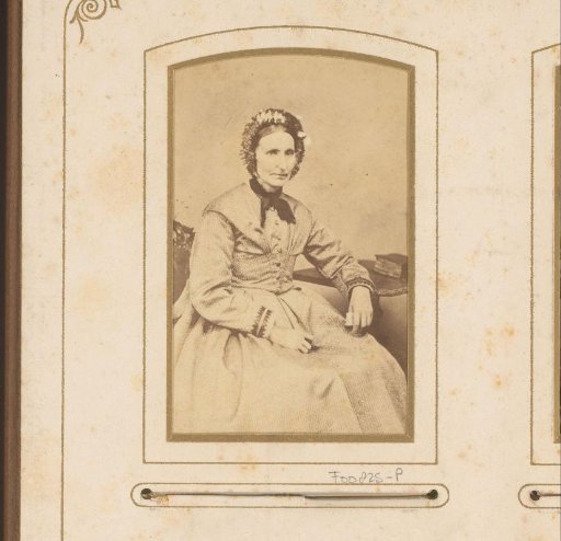 Portrait of a woman with a cap, seated at a table