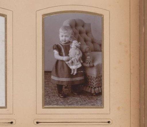 Portrait of a Standing Child Holding a Doll