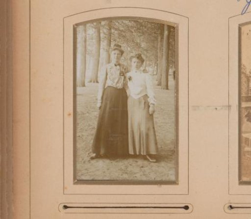 Portrait of Two Young Women Standing on an Avenue with Trees