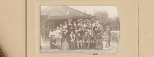 Group portrait of a company at the fair in front of a Steam Bicycle tent