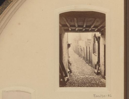 Cobblestone street through a gate