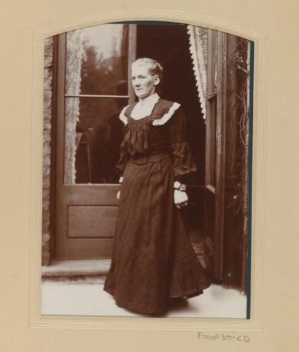 Portrait of a standing woman by garden doors