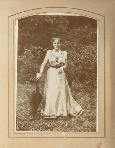 Portrait of a Woman with an Umbrella in a Garden