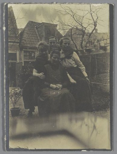 Group portrait of three women and a man in a garden