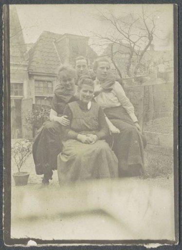 Group portrait of three women and a man in a garden