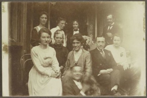 Group portrait of a group of men and women, presumably at a festive occasion