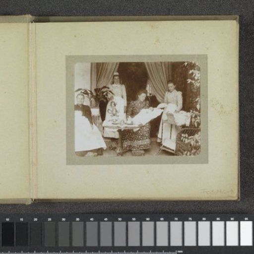 Two women with babies in christening gowns on their laps, in the background two maids with a teapot and a sewing basket