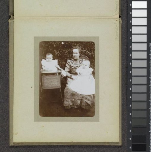 Portrait of a woman with two babies on her lap, probably the twins Ad and Johanna van der Kop with a family member