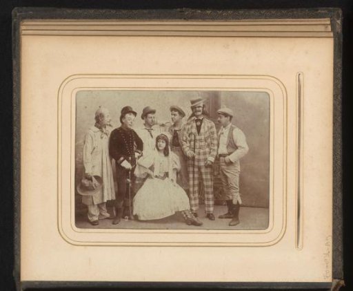 Studio portrait of a theatre company in front of a backdrop
