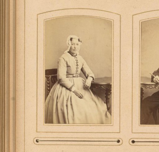 Portrait of a Woman in a White Traditional Cap, Seated at a Table