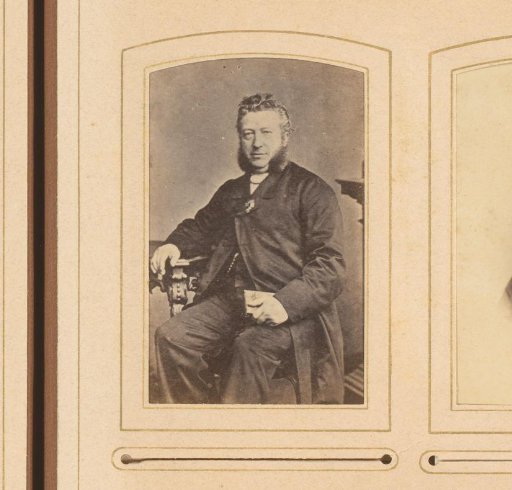 Portrait of a seated man with sideburns