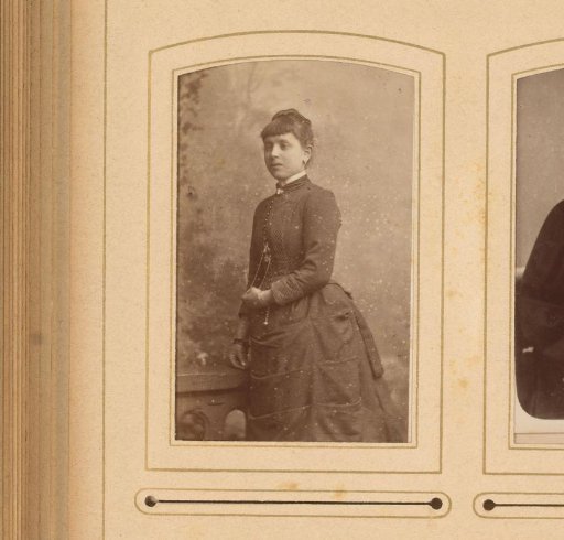 Portrait of a young woman standing by a balustrade