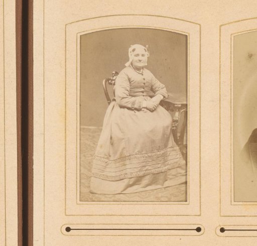 Portrait of a Woman in a Traditional Cap, Seated at a Table