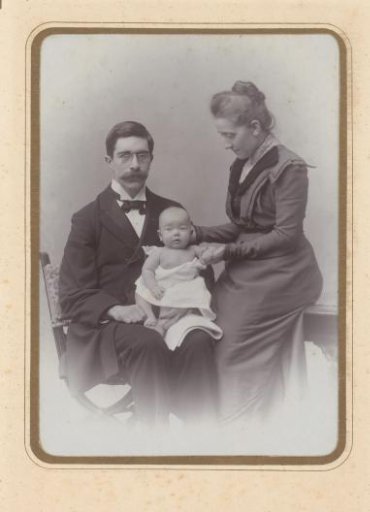 Portrait of a man and woman with a baby