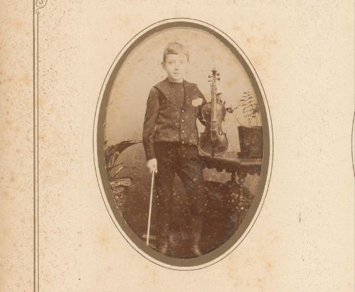 Portrait of a standing boy with violin and bow