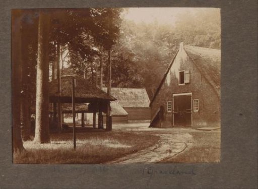 Farmhouse with an empty hay barn at 's-Graveland