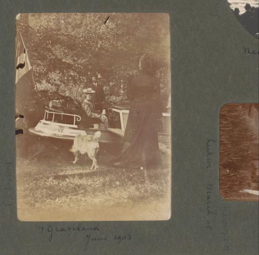 Woman sitting behind the wheel of a pleasure boat with inscription 'Loosdrecht E. Hennipman'