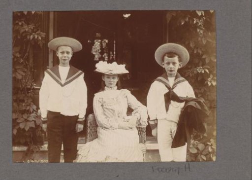 Group portrait of a girl with a hat and two boys in sailor suits, probably in the Netherlands