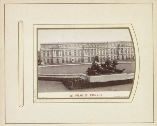 Palace of Versailles with a pond with a statue in the foreground