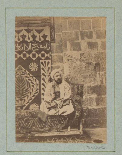 Seated Egyptian man on a divan