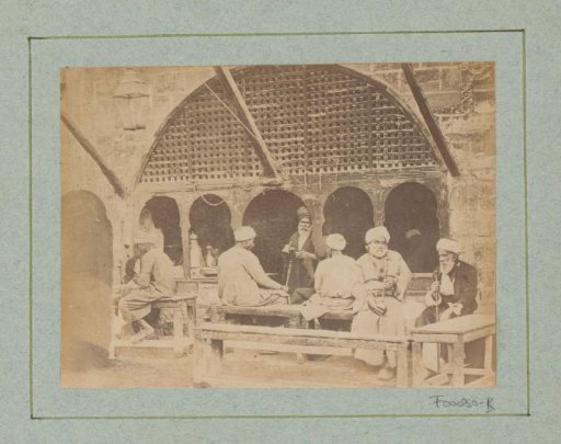Seated Egyptian men with a staff